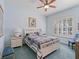 Serene bedroom featuring a white bed frame, window shutters, and light blue walls at 3000 Nw 79Th Avenue Rd, Ocala, FL 34482