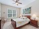Bedroom with a wooden sleigh bed, window, and wooden dresser at 3000 Nw 79Th Avenue Rd, Ocala, FL 34482