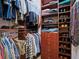 Well-organized walk-in closet with shelves and hanging rods at 3000 Nw 79Th Avenue Rd, Ocala, FL 34482