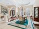 Formal dining room with chandelier and teal area rug at 3000 Nw 79Th Avenue Rd, Ocala, FL 34482