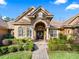 Elegant home exterior with stone accents and arched entryway at 3000 Nw 79Th Avenue Rd, Ocala, FL 34482