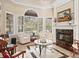 Sunlit Gathering room with a fireplace and access to the backyard at 3000 Nw 79Th Avenue Rd, Ocala, FL 34482
