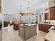 Open concept kitchen with island and views to the Gathering room at 3000 Nw 79Th Avenue Rd, Ocala, FL 34482