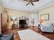 Spacious living area with hardwood floors, a large TV, and comfortable seating at 3000 Nw 79Th Avenue Rd, Ocala, FL 34482
