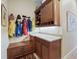 Functional mudroom with built-in cabinets, bench, and coat hooks at 3000 Nw 79Th Avenue Rd, Ocala, FL 34482