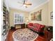 Bright office with built-in bookshelves, hardwood floors, and a comfy couch at 3000 Nw 79Th Avenue Rd, Ocala, FL 34482