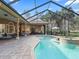 Spacious pool area with covered patio, grill, and lush landscaping at 3000 Nw 79Th Avenue Rd, Ocala, FL 34482