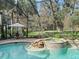 Inviting spa and freeform pool with screened enclosure at 3000 Nw 79Th Avenue Rd, Ocala, FL 34482
