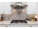 Stainless steel range hood and gas cooktop with granite countertop at 8417 Sw 93Rd Cir, Ocala, FL 34481