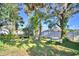 Backyard with picnic table, mature trees and lush landscaping at 6121 County Road 547 N, Davenport, FL 33837