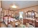 Spacious bedroom with a wooden four-poster bed and ample dresser space at 6121 County Road 547 N, Davenport, FL 33837