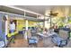 Large covered porch with seating, dining, and ceiling fan at 6121 County Road 547 N, Davenport, FL 33837