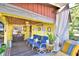 Relaxing covered porch with seating area, ceiling fan, and potted plants at 6121 County Road 547 N, Davenport, FL 33837