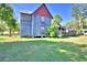Two-story house with gray siding, red trim, and a porch at 6121 County Road 547 N, Davenport, FL 33837