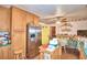 Kitchen boasts wood cabinets, stainless steel refrigerator, and island at 6121 County Road 547 N, Davenport, FL 33837