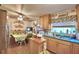 Kitchen with wood cabinets, a breakfast nook, and stainless steel refrigerator at 6121 County Road 547 N, Davenport, FL 33837