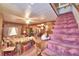 Living room with pink carpet, wooden walls, and sofas at 6121 County Road 547 N, Davenport, FL 33837