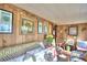 Cozy living room features wood walls, comfy seating, and a decorative Christmas tree at 6121 County Road 547 N, Davenport, FL 33837