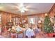Living room with wood paneling, Christmas tree, and vintage furniture at 6121 County Road 547 N, Davenport, FL 33837