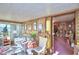 Living room with wooden walls and pink carpet at 6121 County Road 547 N, Davenport, FL 33837