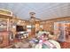 Spacious living room with wood paneling and various furniture at 6121 County Road 547 N, Davenport, FL 33837