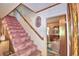 Pink carpeted staircase leads to the upper level of the home at 6121 County Road 547 N, Davenport, FL 33837