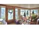 Bright sunroom with wooden walls and plenty of windows at 6121 County Road 547 N, Davenport, FL 33837
