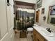 Bathroom with a horse-themed shower curtain and wood vanity at 4880 Bannon Island Rd, Haines City, FL 33844