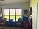 Bedroom with large window, antique furniture, and TV at 4880 Bannon Island Rd, Haines City, FL 33844