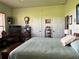 Main bedroom with large bed, TV, and antique furniture at 4880 Bannon Island Rd, Haines City, FL 33844