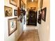 Long hallway with decorative wall art and antique furniture at 4880 Bannon Island Rd, Haines City, FL 33844