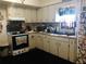 Kitchen with white cabinets and appliances at 323 Dorsett Ave, Lake Wales, FL 33853