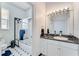 Small bathroom with shower/tub combo and black and white tile floor at 3082 Landings Ct, Haines City, FL 33844