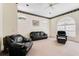 Living room with leather furniture and large windows providing ample natural light at 3082 Landings Ct, Haines City, FL 33844
