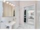 Bathroom with pedestal sink, mirrored medicine cabinet, and access to a large walk-in closet at 3082 Landings Ct, Haines City, FL 33844