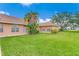 Spacious backyard with lush lawn and access to the house at 3082 Landings Ct, Haines City, FL 33844