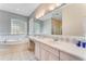 Bathroom with a garden tub, double vanity, and tiled flooring at 3082 Landings Ct, Haines City, FL 33844