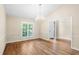 Bright dining room with hardwood floors, crown molding and chandelier, view to entryway at 110 Woden Way, Winter Haven, FL 33884