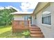 Wooden deck with lattice railing, steps, and potted plant at 814 Cambridge Way, Lake Wales, FL 33853