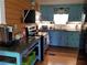 Charming kitchen features blue cabinets, granite countertops, and modern appliances at 315 Virginia St, Frostproof, FL 33843