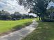 Scenic walkway alongside a lush green golf course at 2213 Mallory Cir, Haines City, FL 33844