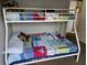Bedroom with a bunk bed and colorful bedding at 2213 Mallory Cir, Haines City, FL 33844