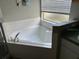 Bathroom with corner soaking tub and shower at 2213 Mallory Cir, Haines City, FL 33844