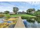 Lakefront home with a dock, expansive lawn, and a large patio at 514 Hillside Dr, Auburndale, FL 33823