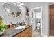 Elegant bathroom with granite countertop, decorative mirror, and shower at 514 Hillside Dr, Auburndale, FL 33823