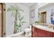 Bathroom with walk-in shower, granite vanity, and tropical mural at 514 Hillside Dr, Auburndale, FL 33823