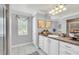Bright bathroom, featuring a double vanity and tiled floors at 514 Hillside Dr, Auburndale, FL 33823