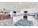 Open concept kitchen with white cabinets, granite countertops and island at 514 Hillside Dr, Auburndale, FL 33823