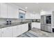 Modern kitchen with white cabinets, granite countertops and stainless steel appliances at 514 Hillside Dr, Auburndale, FL 33823