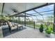 Relaxing screened porch overlooking the lake with outdoor furniture at 514 Hillside Dr, Auburndale, FL 33823